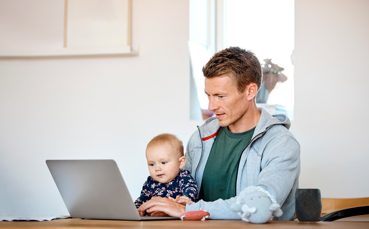 man-with-baby-on-computer
