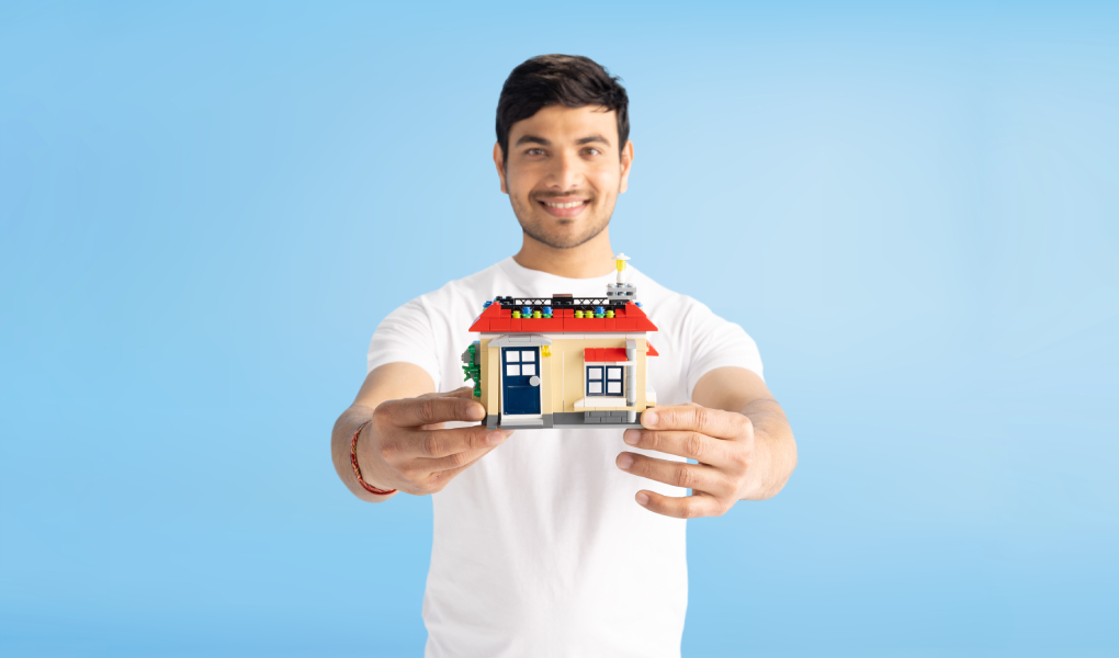 Man holding a model house